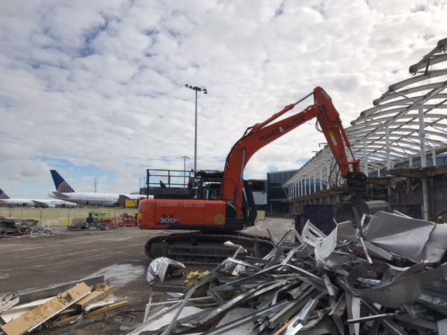Excavator carrying out demolition work at an airport