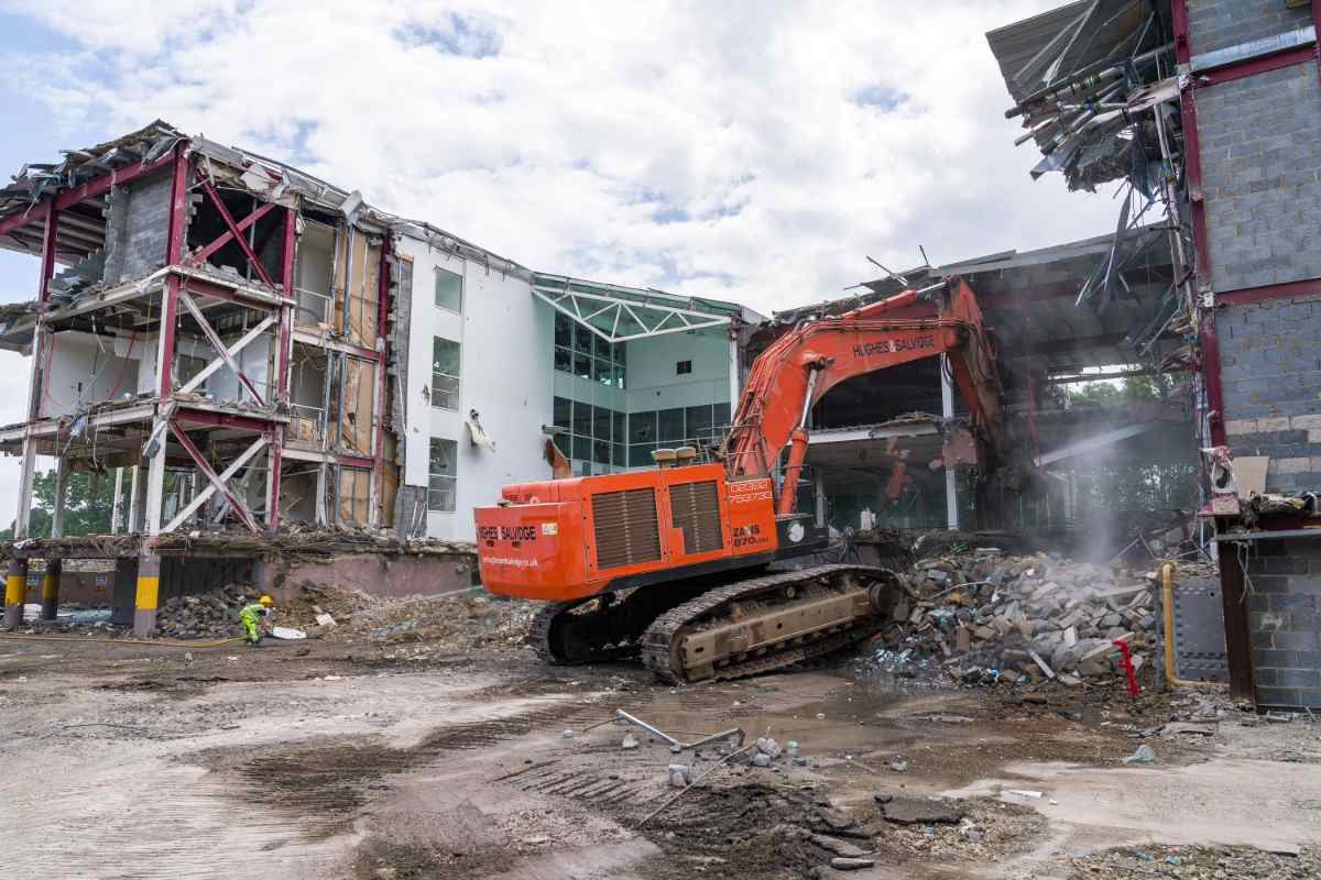 Demolition of high building with hydraulic excavator - it's safe to assume this required planning permission.